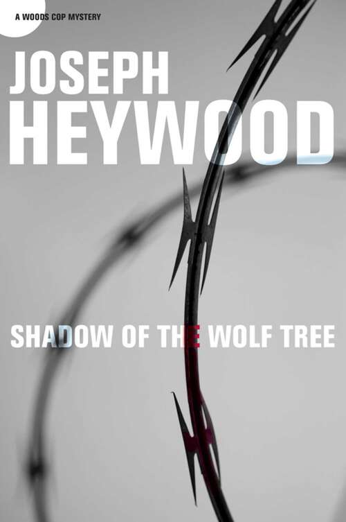 Book cover of Shadow of the Wolf Tree: A Woods Cop Mystery