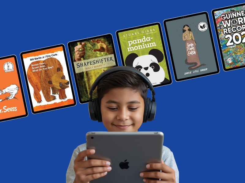 student wearing headphones and reading on a tablet with various book covers in tablets in the background