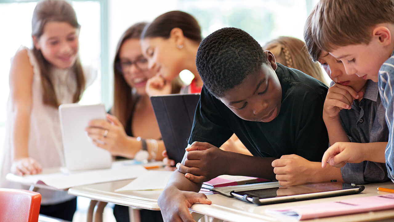 School kids in class using a digital tablet